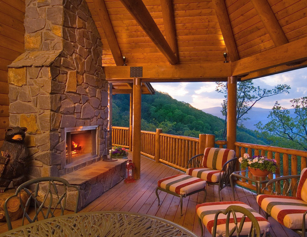 Wrap-around log cabin deck in the mountains treated with Outlast® CTA Products