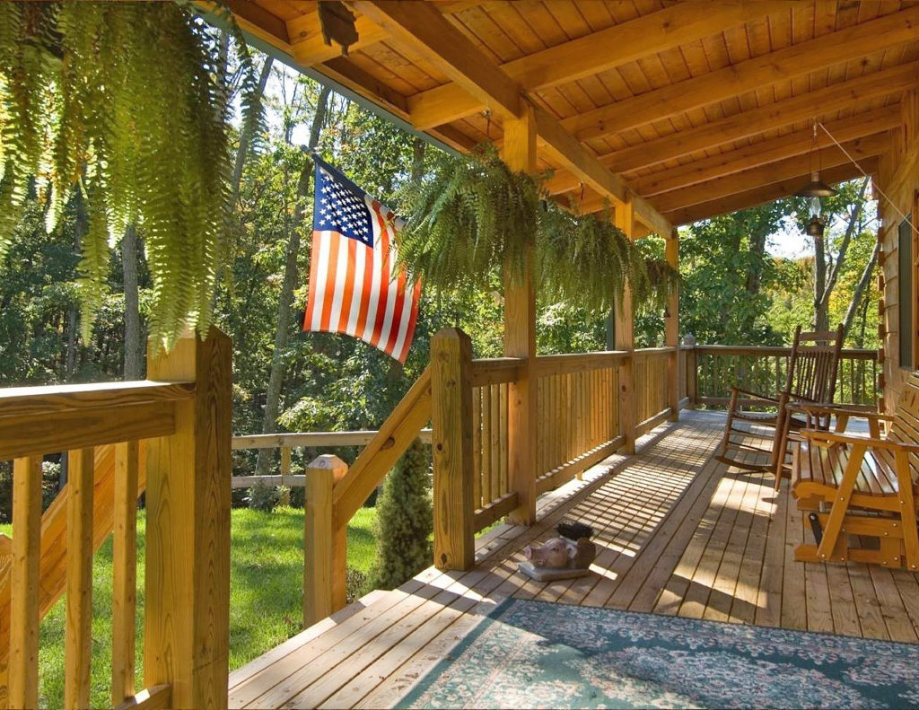 Large log cabin deck in the woods flying the American flag - Outlast® CTA Products
