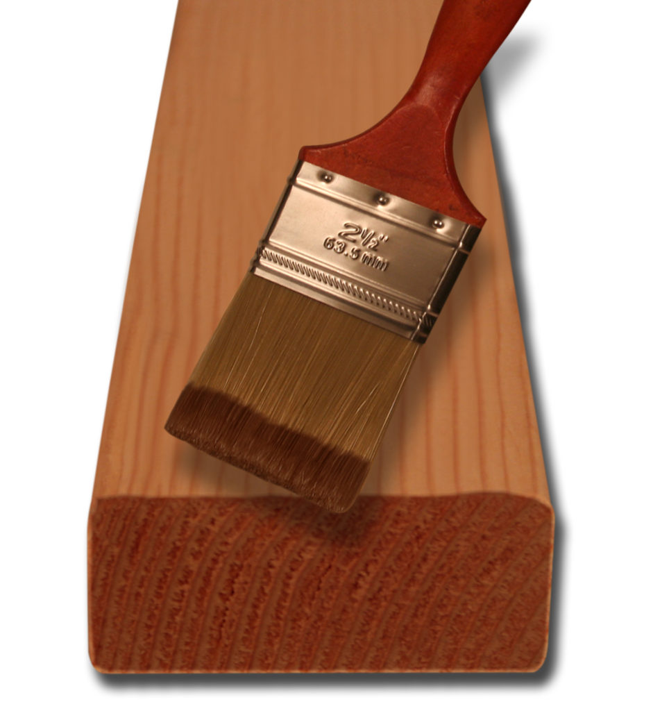 Paint brush on top of a 2x4
