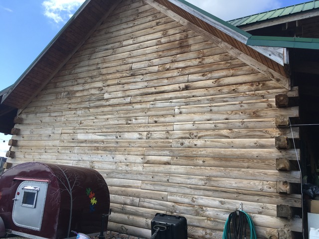 Side of log home treated with Outlast® CTA Log Home Preservative Products