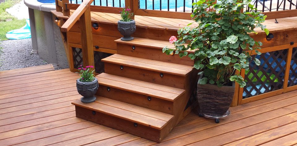 Deck stairs leading to above-ground pool treated with Outlast® CTA Products