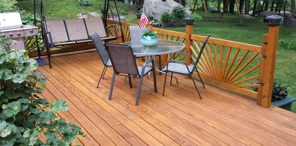 Light color-stained deck with table and swing treated with Outlast® CTA Products