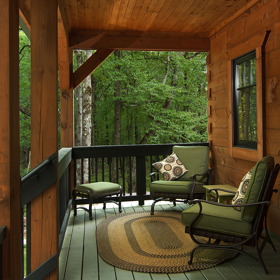 Small log cabin porch treated with Outlast® Q8 Log Oil CTA Products
